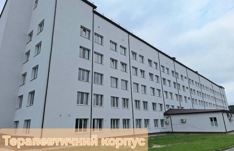 Зовнішній вигляд п'ятиповерхового терапевтичного корпусу Макарівської лікарні з оновленим, утепленим та пофарбованим у білий колір фасадом і новими вікнами.